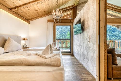 a bedroom with a bed and a window at Dahoam-Apartments by A-Appartments in Bürserberg