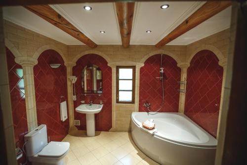 a bathroom with a tub and a sink at Turiyske Podvir'ya in Blazhennik