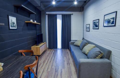 a living room with a couch and a table at Liliana's Apartments in Kutaisi