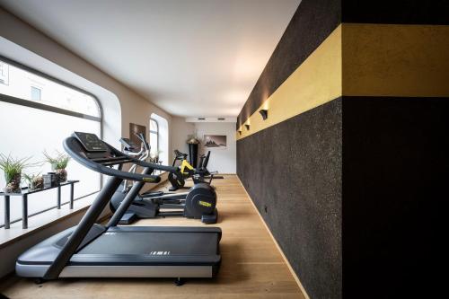 a gym with two treadmills and a treadmill at Post Hotel - Tradition & Lifestyle Adults Only in San Candido
