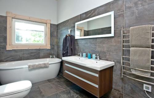 a bathroom with a sink and a tub and a toilet at Cutterbrough, Great Field Lodges in Braunton