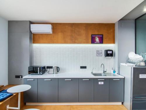 a small kitchen with a sink and a refrigerator at AV-1 Capsule Hotel in Kyiv