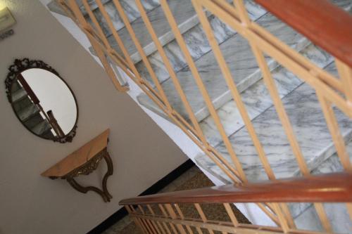 a spiral staircase with a mirror on the wall at Hotel Bologna in Genova