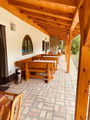a row of wooden pews in a church with benches at Fonfa Liget in Sénye