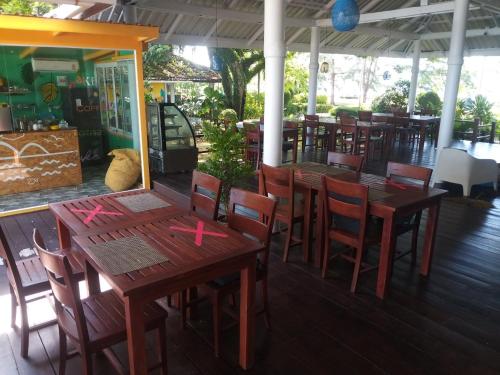 a dining room table with chairs and tables at Twin Bay Resort - SHA Extra Plus in Ko Lanta