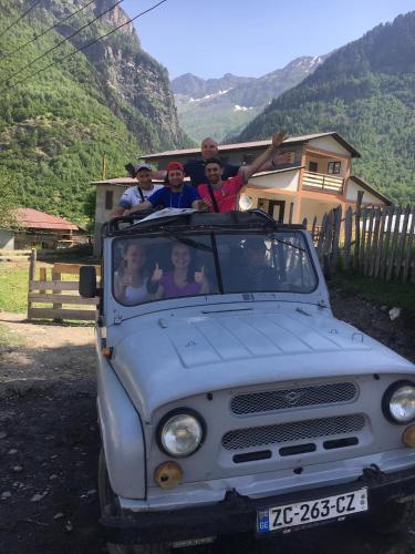 a group of people sitting in the back of a truck at Guest House Victor in Zhabeshi