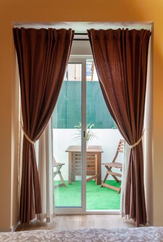 a sliding glass door with a view of a table at Marittimo Apartments in Valencia