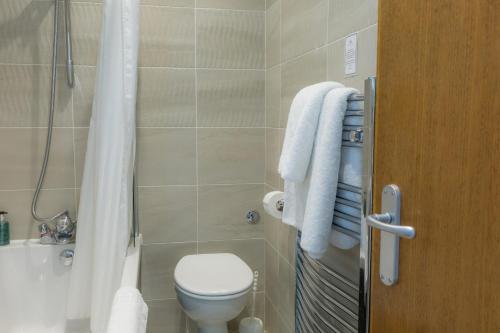 a bathroom with a toilet and a sink and a shower at Best Western Sysonby Knoll Hotel in Melton Mowbray