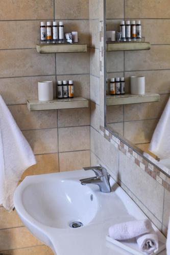 a bathroom with a sink and a mirror at Toxotis Villas in Armenistis