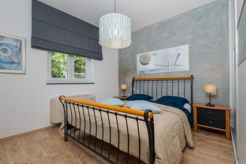 a bedroom with a large bed with blue pillows at Villa Vires in Labin