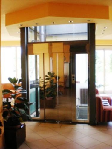 a lobby with a glass door in a building at Hotel Florida Tirrenia in Tirrenia