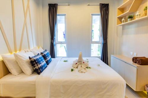 a bedroom with a bed with a stuffed animal on it at Honeybee Pool Villa Smooth as Silk in Ao Nang Beach
