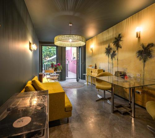 a living room with a yellow couch and a table at toctoctoc lisboa in Lisbon