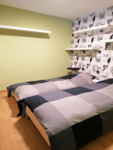 two beds in a room with posters on the wall at les rainettes in Grand-Halleux