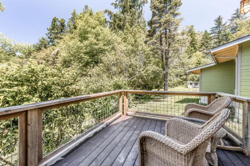 two chairs on a deck with trees in the background at 2 Bed 1 Bath Vacation home in Gold Beach in Gold Beach