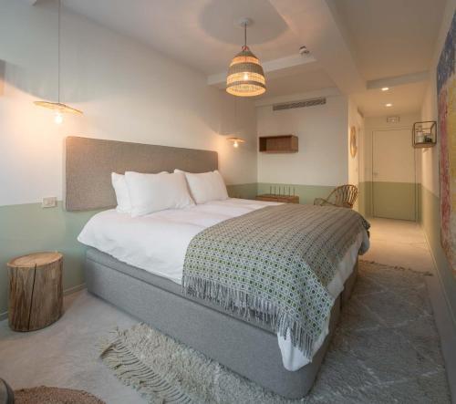 a bedroom with a large bed in a room at toctoctoc lisboa in Lisbon