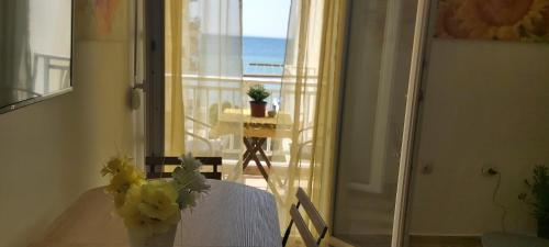 a room with a table and a view of the ocean at Perea Silvi suite in Perea