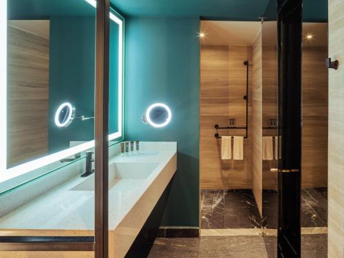 a bathroom with a sink and a shower at Novotel Mexico City Toreo in Mexico City