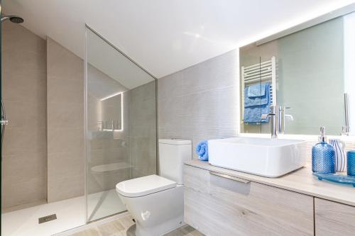 a bathroom with a white toilet and a sink at El Nido in Manzanares el Real