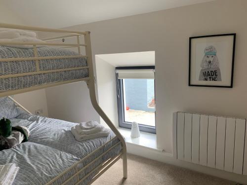 a bedroom with a bunk bed and a window at Traditional Farm House in the Old Head of Kinsale in Cork