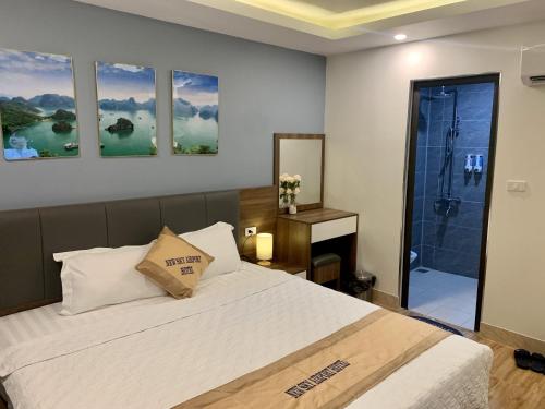 a bedroom with a large bed and a shower at New Sky Airport Hotel in Noi Bai