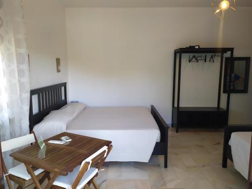 a small bedroom with a bed and a table at B&B Tra Mare e Marmo in Marina di Carrara
