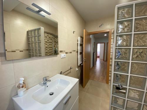 a bathroom with a sink and a mirror at Cedemar 1 in Cedeira