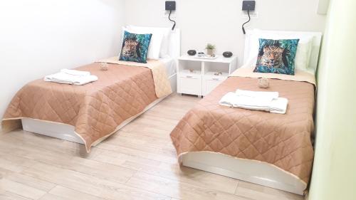 a bedroom with two beds and a wooden floor at Casa Doppia in Zakynthos Town