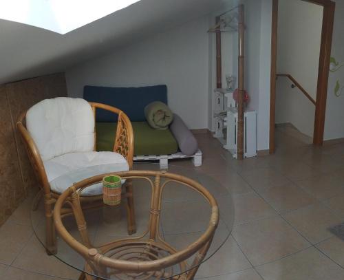a living room with a chair and a couch at Green House in Baleal