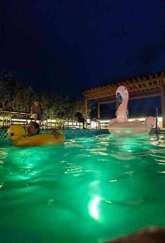 two people in an outdoor swimming pool at night at Heaven's Gate Home Stay --free pick up service--panoramic view of Tianmen Mountain in Zhangjiajie