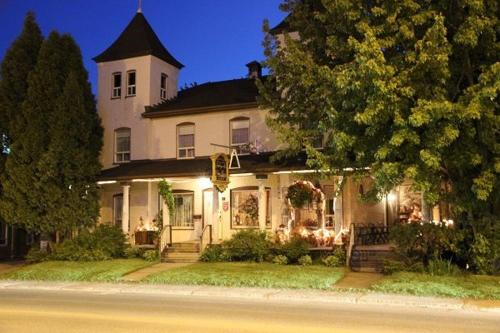 a large white house with a tower on top of it at auberge les deux tours in Jonquiere