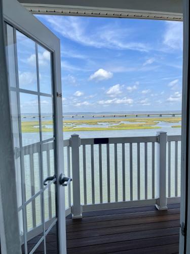 a balcony with a view of the ocean at Comfort Suites Chincoteague Island Bayfront Resort in Chincoteague