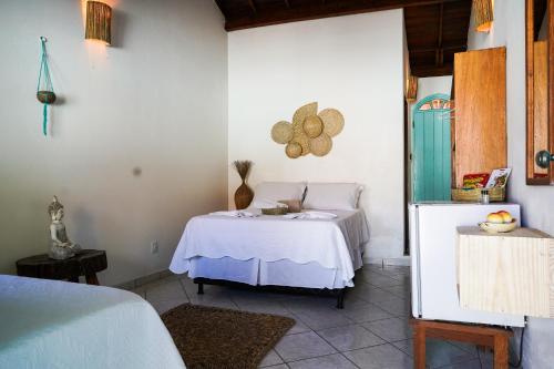 una camera da letto con un letto in una stanza di Pousada Coração do Arraial a Arraial d'Ajuda