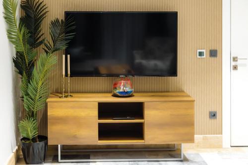 a wooden entertainment center with a flat screen tv at Home Of Istanbul in Istanbul