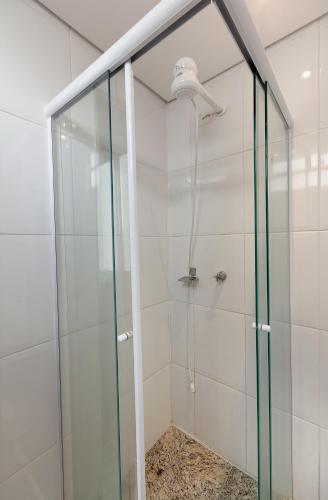 a shower with a glass door in a bathroom at Fênix Hotel Bom Retiro in Sao Paulo