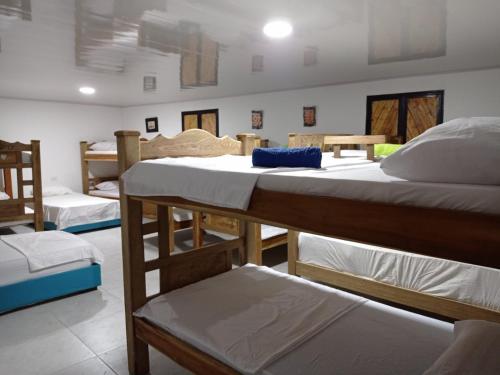 a group of beds in a room with at Apartamentos Vistas del Caribe Sede Campestre in Cartagena de Indias