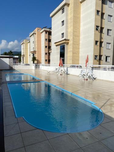 a large swimming pool in front of some buildings at Apartamento Aconchegante Sun Way in Ubatuba