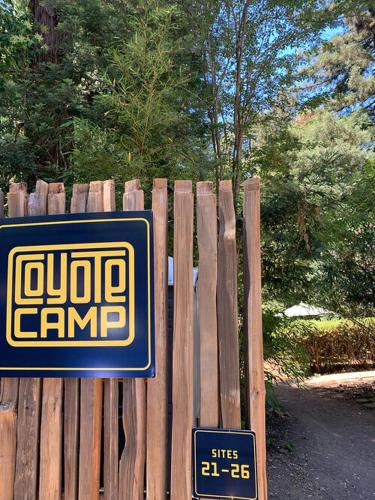 a sign on a wooden fence in front of a yard at Highlands Resort - Adults Only in Guerneville