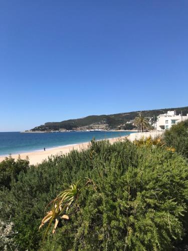 a view of a beach and the ocean at Cosy room with bathroom and private access in Sesimbra