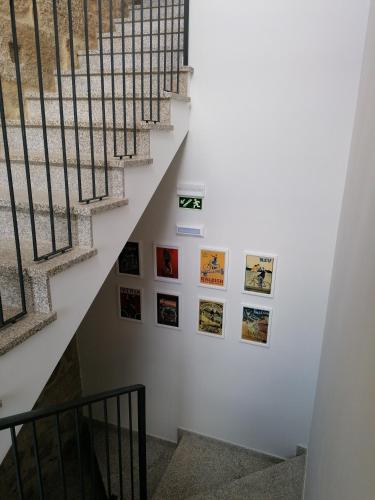a staircase with pictures on the wall at BIKEINN in Vouzela