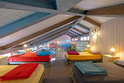 a room with four beds in a attic at Quinta Estrada Romana - Albergue de Peregrinos in Cerdal