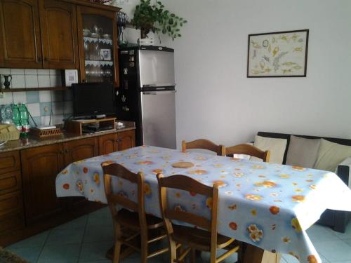 a kitchen with a table and a refrigerator at PonzaSmeralda Le Forna in Ponza