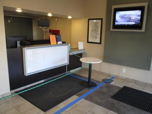 a waiting room with a large screen on the wall at Travelodge by Wyndham Lansing in Lansing