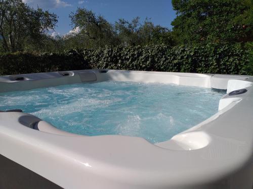 a jacuzzi tub with blue water in it at Villalvento in Brenzone sul Garda