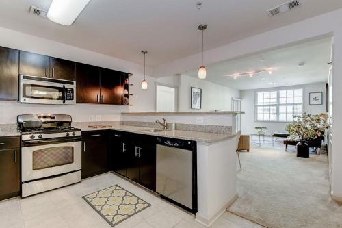 a large kitchen with a stove and a sink at National at Clarendon in Arlington