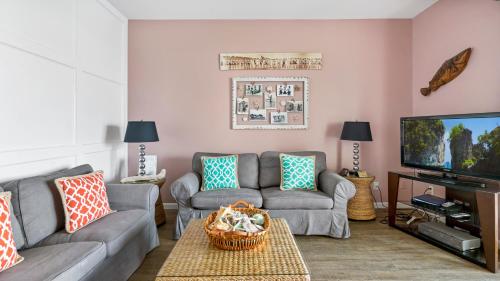 a living room with a couch and a tv at The Hermitage at Napeague in Amagansett