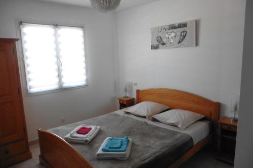 a bedroom with a bed with two trays on it at Escapade Audoise in Sallèles-dʼAude