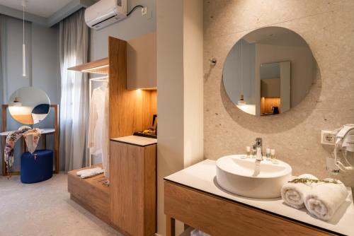 a bathroom with a sink and a mirror at Syvota Gardens in Syvota