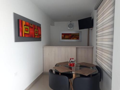 a dining room with a table and black chairs at HOTEL SAN PEDRO in La Paz