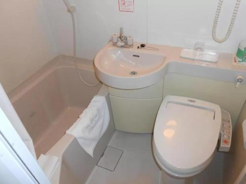 a bathroom with a toilet and a sink and a tub at R&B Hotel Kanazawa Station Nishiguchi - Vacation STAY 39078v in Kanazawa